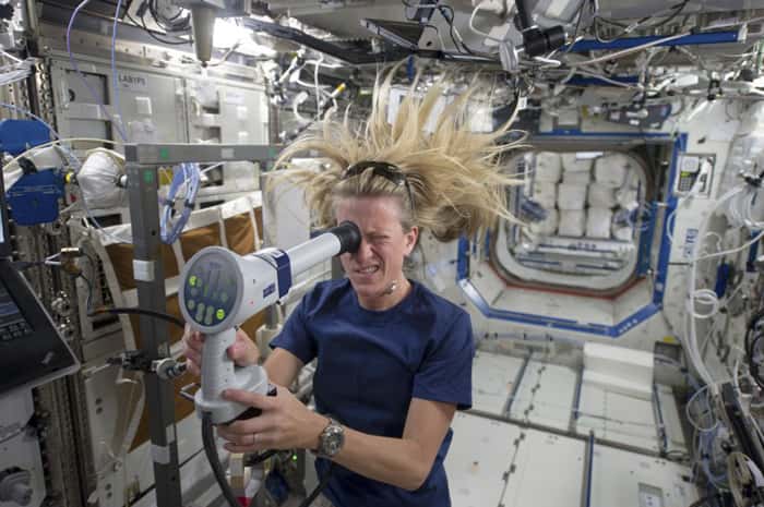 NASA astronaut Karen Nyberg uses a fundoscope